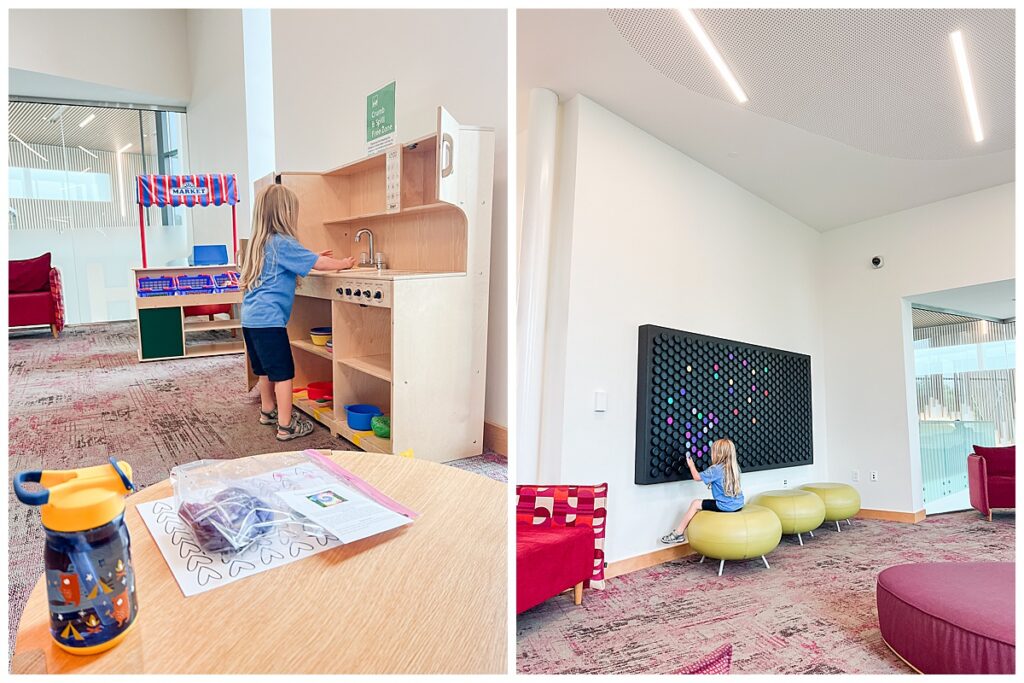 A child playing with a play kitchen and a light board at a local library.